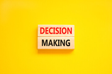 Decision making symbol. Concept words Decision making on wooden blocks. Beautiful yellow table yellow background. Business and decision making concept. Copy space.