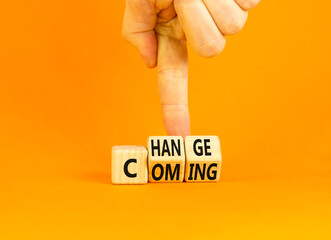 Change is coming symbol. Concept words Change and Coming on wooden cubes. Beautiful orange table...