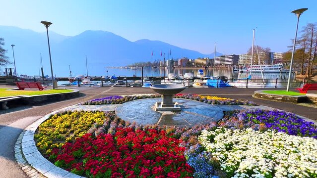 Colored flower beds around the fountain in lakeside park of Locarno, Switzerland