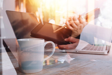 businesswoman hand working with laptop computer, tablet and smart phone in modern office with virtual icon diagram at modernoffice in morning light