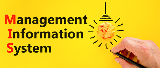 MIS management information system symbol. Concept words MIS management information system on a beautiful yellow background. Light bulb. Business MIS management information system concept. Copy space © Dzmitry