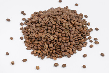 Fragrant and roasted coffee beans on a white background, place for inscription and advertising.