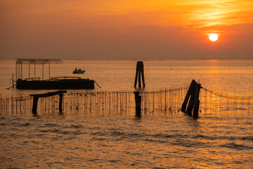 Venice lagoon, mussel farm in Chioggia skyline at sunset