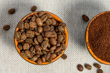 Ground and whole-grain coffee on a light background.