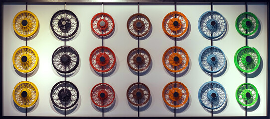 multicolored car wheels mounted on wall bracket