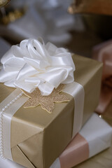 Christmas gifts in craft paper under the Christmas tree, spruce branches.Happy new year vertical background.