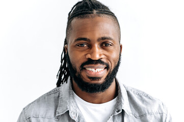 Close-up photo of an attractive black guy, african american man, with dark brown eyes, with...