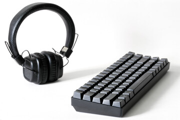 Professional mechanical computer keyboard and wireless headphones on a white background. Audio recording studio, audio streaming and digital audio broadcasting. Copy space. Selective focus.