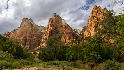 Naklejka na ściany i meble The Court of the Patriarchs is a grouping of sandstone cliffs in Zion National Park. The mountain is named after the biblical figures of Abraham, Isaac, and Jacob.