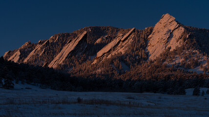 Snow covered Flatirons at dawn