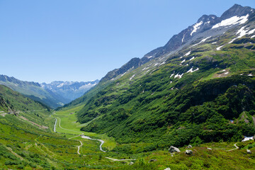 Fototapeta na wymiar Panoramic view of green alpine meadows and mountains