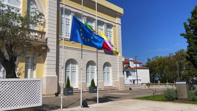 EU flag with Portuguese flag and Sintra flag fluttering in front of the Museum of Modern Art in Sintra