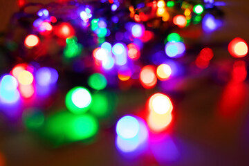 Abstract background with colorful sparkling bokeh on a dark background. Holiday concept