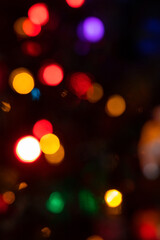 Abstract background with colorful sparkling bokeh on a dark background. Holiday concept
