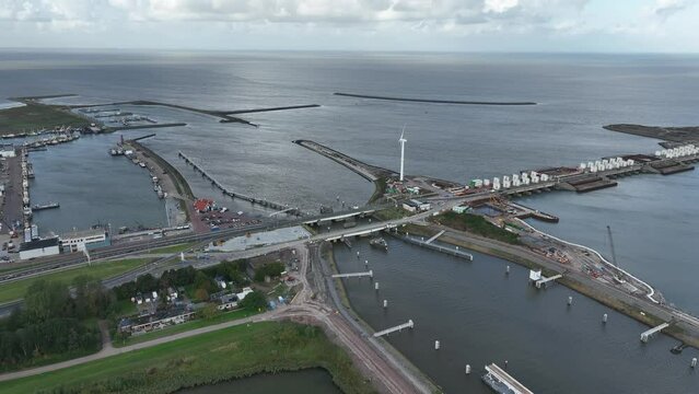 Afsluitdijk construction on pumping stations new sluices and the A7 near Den Oever, Kornwerderzand , and Zurich. Lock for shipping, road traffic cyclists and walkers. Aerial drone view.