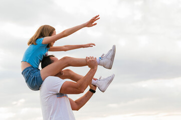 Father playing with his little daughter outdoors.