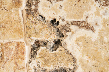 Macro shot of granite or marble stone structure with brown white marbling and spots. Marble stone surface with texture pattern. Marble countertop, tile, path, wall. Facing stone with marbled structure