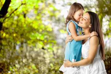young happy mother with daughter have fun in park