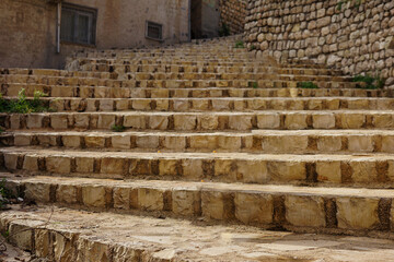 Fototapeta premium Old stone stairs leading to houses on the streets of Mardin