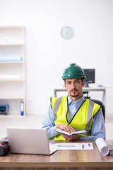 Young male architect working in the office