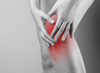 Knee cap, meniscus pain, trauma close up. Hand touching injured red kneecap