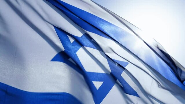 israel flag fluttering in the wind. real footage not graphics. backlit flag and bright sun. High quality 4k footage

