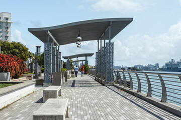 Puerto rico modern grey city bay walkway with a couple holding hands from san juan 