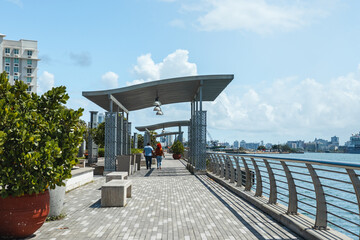Puerto rico modern grey city bay walkway with a couple holding hands from san juan 