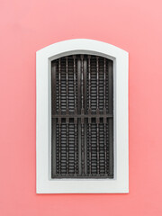 Beautiful minimalist pink wall with wooden window from an apartment in puerto rico san juan 