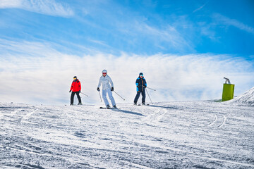 Man and woman skiing down the ski slope or piste in Pyrenees Mountains. Winter ski holidays in El...