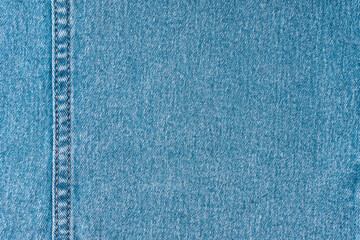 Denim jeans texture background. Texture of blue colored cotton fabric with decorative seam. Stiched...