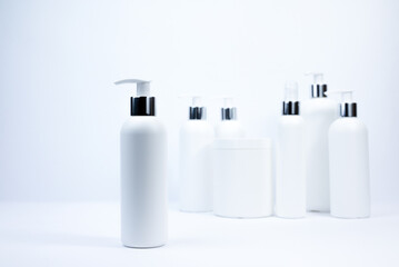 Set of white cosmetic bottles mockup. White plastic bottles with shampoo and conditioner and shower...
