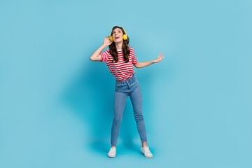 Full length photo of funky dreamy lady wear striped t-shirt headphones having fun singing isolated blue color background
