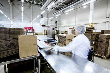 Packaging process in chocolate sweets factory. Food industry