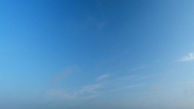 Background of clouds and sky on a sunny day. Light blue and white colours of real skies with clouds. Timelapse.