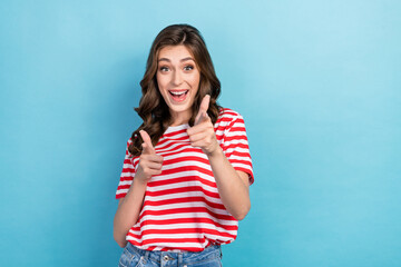 Photo of cool excited girl dressed red t-shirt pointing finger you empty space isolated blue color background