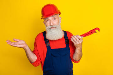 Photo of retired senior artisan architect shrug shoulders have failure fixing pipes isolated on...