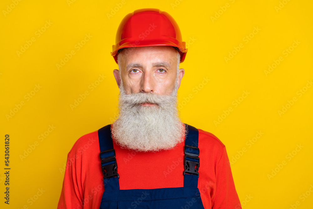 Poster Photo of serious confident age man workwear uniform red hard hat isolated yellow color background