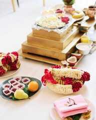 Festive table with traditional food and sweet, decorated with flowers