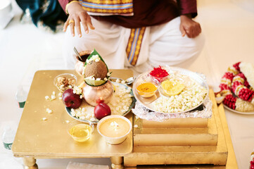 Above view of food ingredients placed on table for Indian traditional ceremony near priest