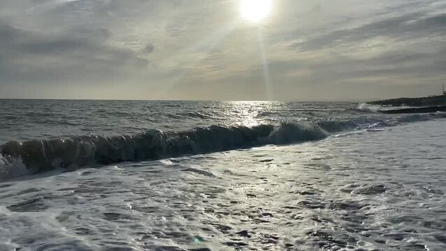 beach ocean waves on shingle pebble UK - popular summer beach destination rugged coast on south of England - stock footage