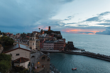 Fototapeta na wymiar Amazing village with vintage houses on a rock by the sea at sunset in Vernazza, Italy