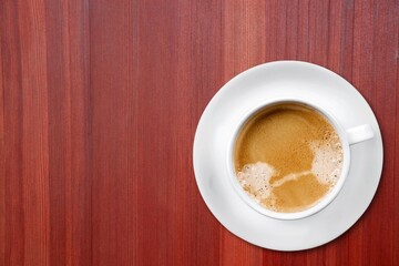 Ceramic cup of sweet coffee on the desk