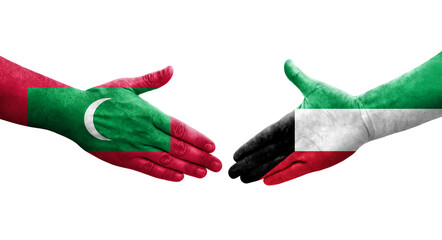 Handshake between Kuwait and Maldives flags painted on hands, isolated transparent image.