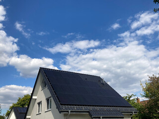 Solaranlage auf einem Einfamilienhaus mit blauem Himmel in Nordrhein-Westfalen, Deutschland	