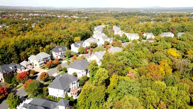 Autumn panorama of the streets of modern single-family houses of the upper and middle class. American real estate in Virginia USA. Drone view.