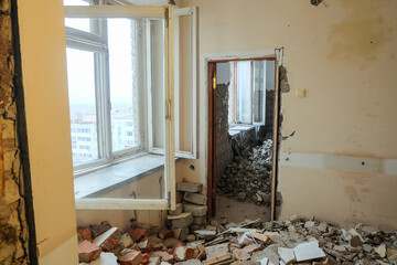 Construction debris in the rooms of the reconstructed building. Dismantled brick partitions and...