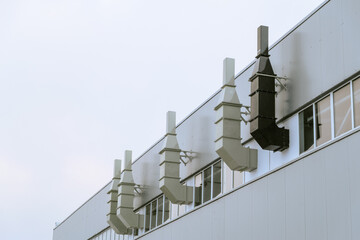 Ventilation ducts on the facade of an industrial building. Engineering air system.
