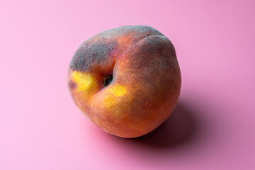 peach close-up on a pink background with a place for the inscription