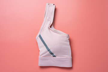 folded pink sports bra for women on pink background